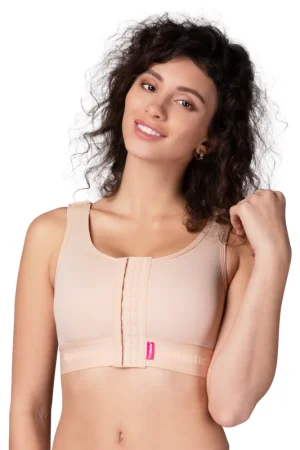 Modella che indossa il reggiseno compressivo PI Ideal Lipoelastic in colore beige, con chiusura frontale a ganci.